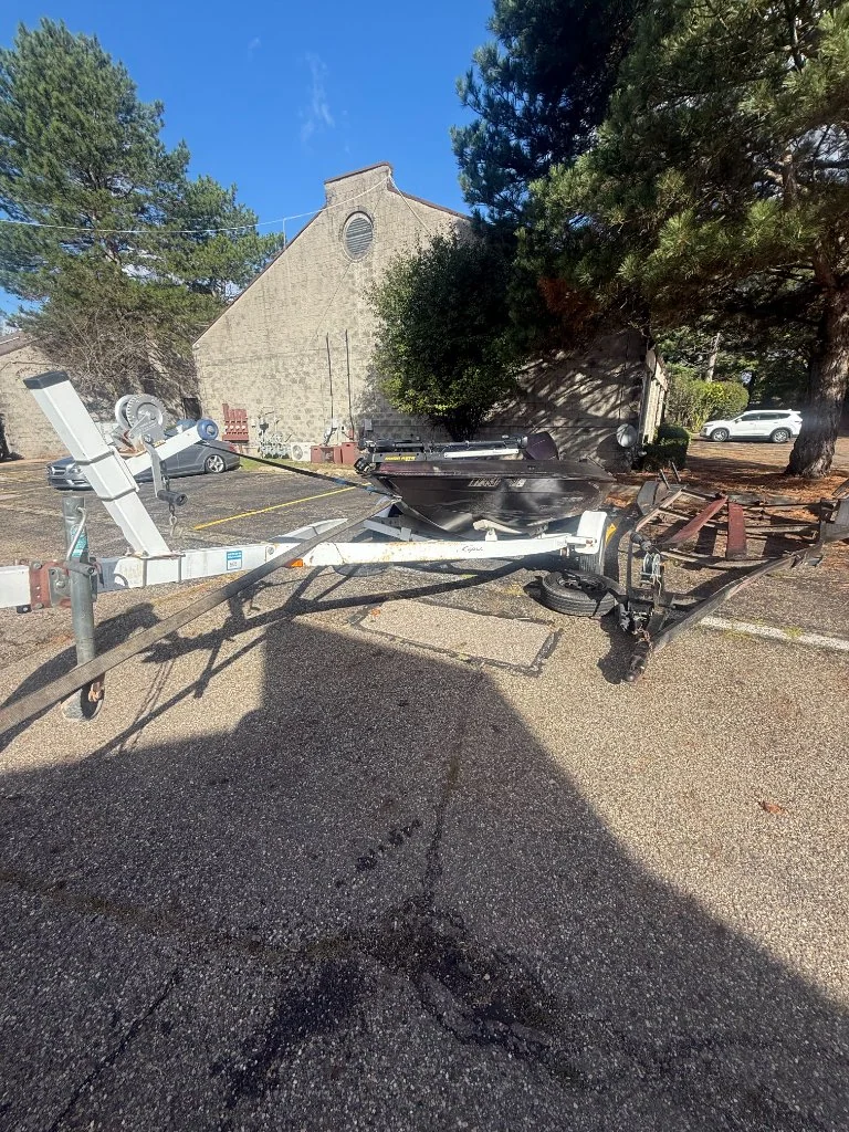 Empty boat trailer positioned in a residential driveway