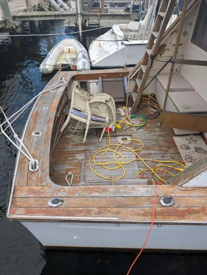 Weathered wooden deck and cabin doorway of an older vessel